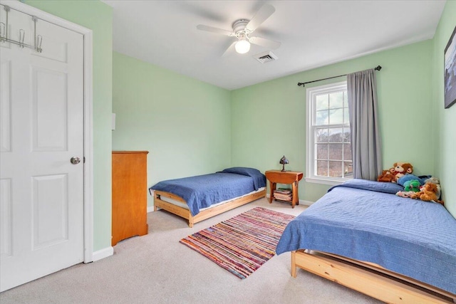 carpeted bedroom featuring ceiling fan, visible vents, and baseboards