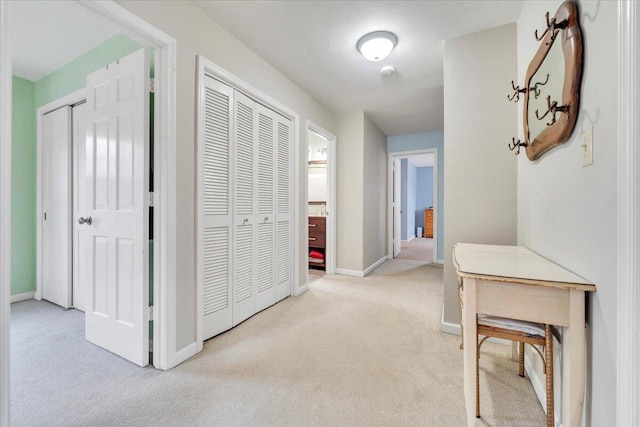 hall with carpet floors and baseboards