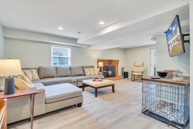 living area with visible vents, wood finished floors, and recessed lighting