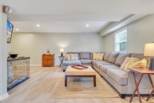 living area featuring baseboards, recessed lighting, and light wood-style floors