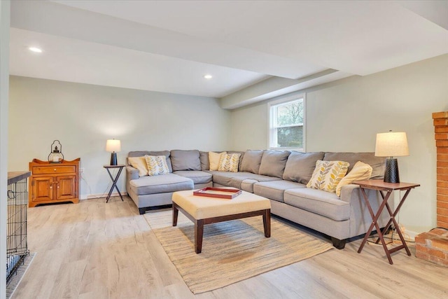 living room featuring recessed lighting, light wood-style flooring, and baseboards