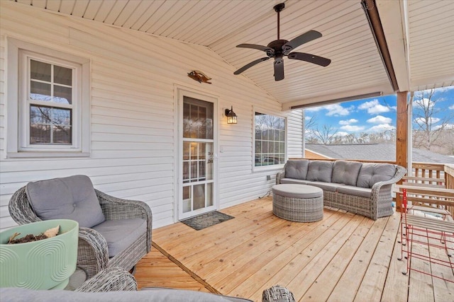 wooden terrace featuring an outdoor living space and a ceiling fan