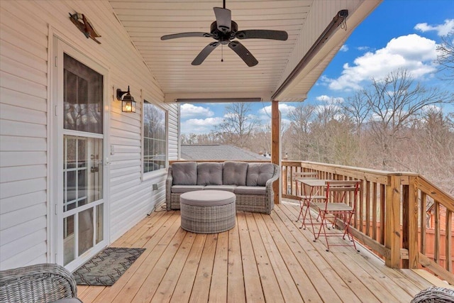 wooden terrace with ceiling fan and an outdoor hangout area