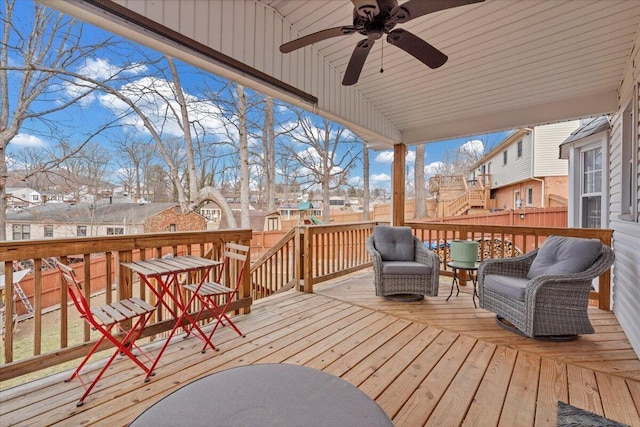 deck featuring a residential view and a ceiling fan