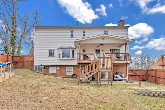 back of property featuring a ceiling fan, stairs, a gate, a deck, and cooling unit