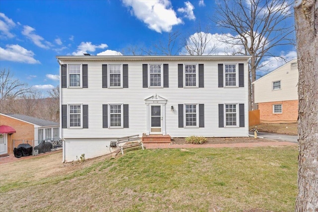 colonial-style house with a front lawn