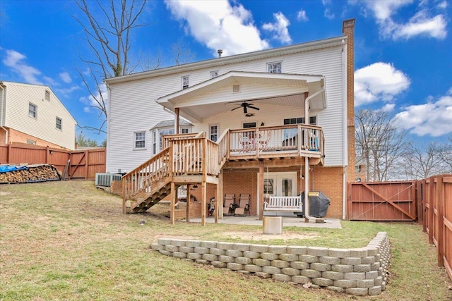 back of property featuring a patio, a fenced backyard, a chimney, a gate, and a deck