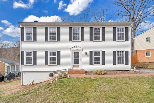 colonial inspired home with a front yard