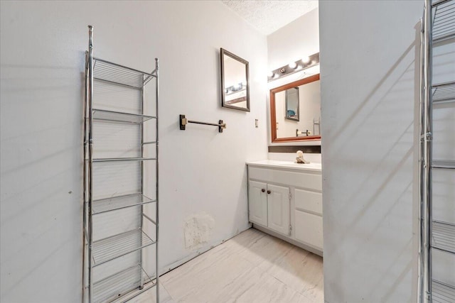 bathroom with a textured ceiling and vanity