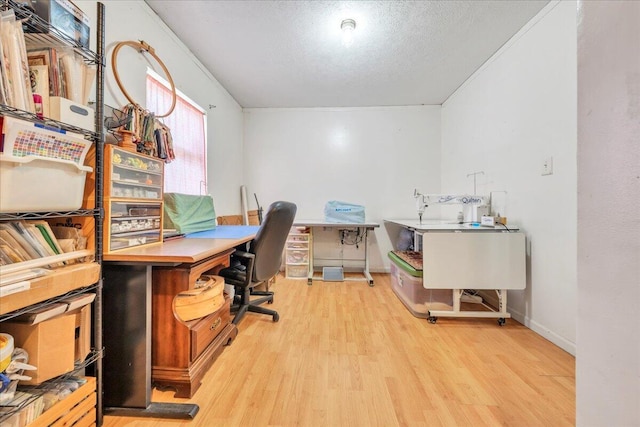 office area featuring a textured ceiling, baseboards, and wood finished floors