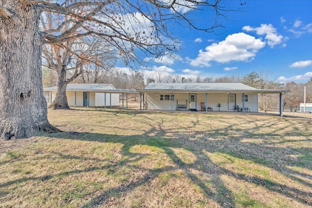 view of front of home with a front yard and metal roof