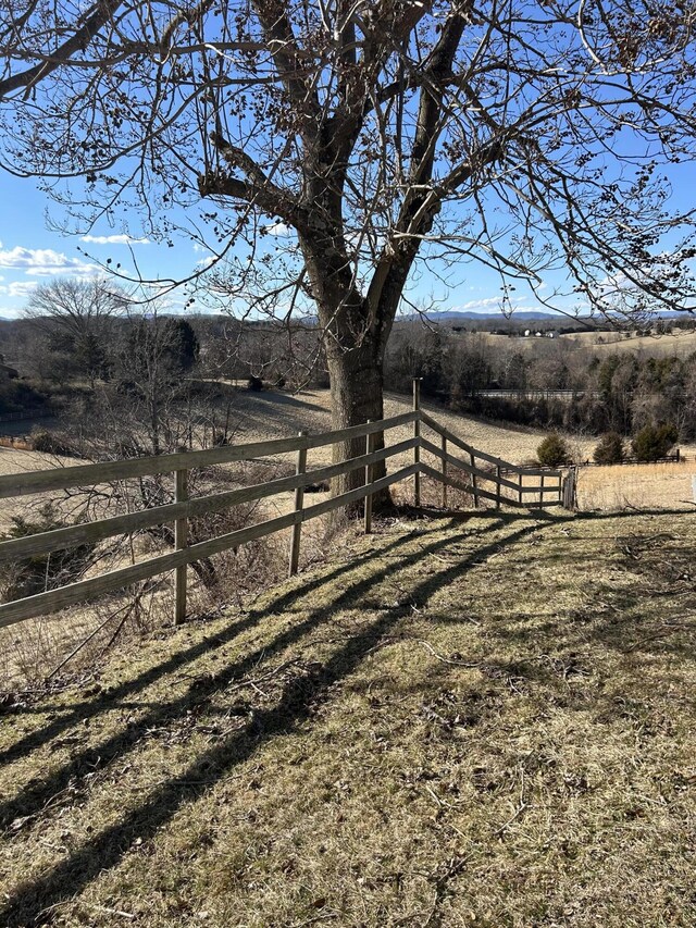 view of yard featuring a rural view and fence