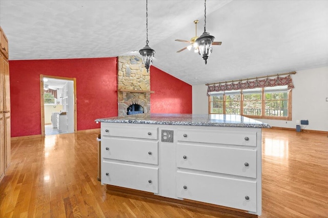 kitchen featuring lofted ceiling, a ceiling fan, light wood finished floors, and plenty of natural light