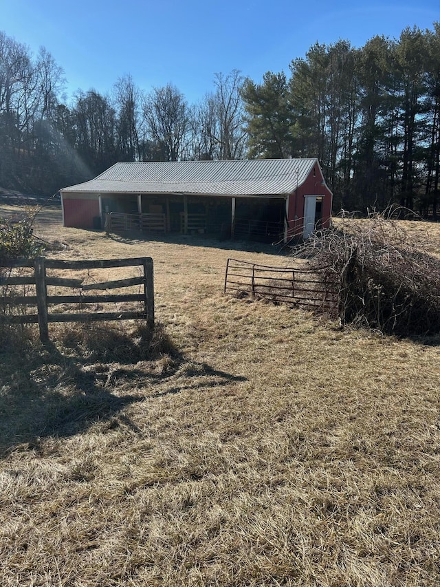 exterior space featuring an outbuilding, metal roof, and an exterior structure