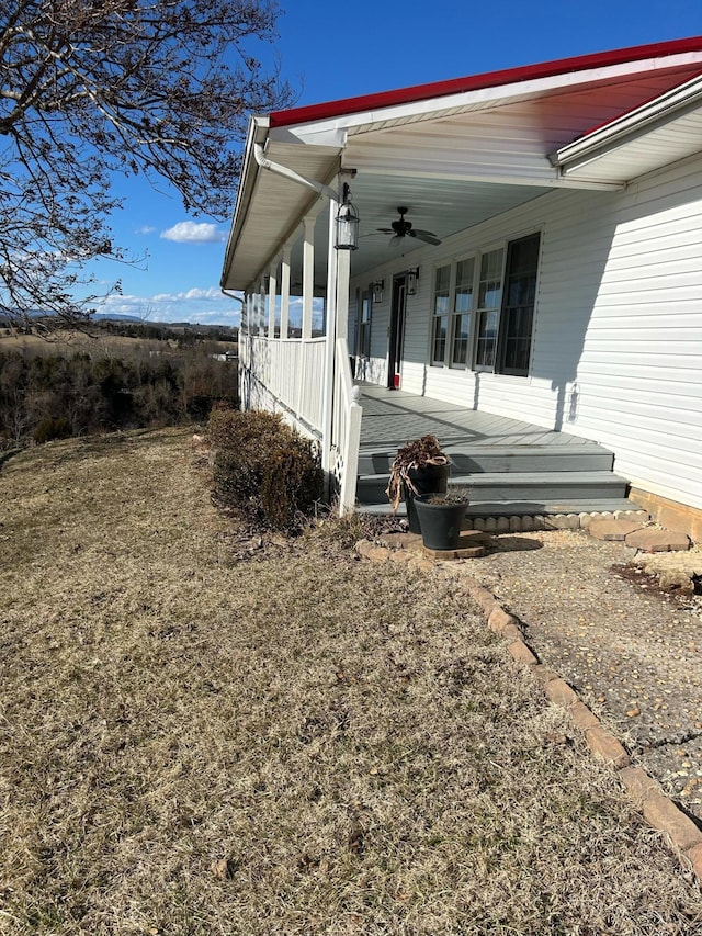 view of side of property featuring covered porch and ceiling fan