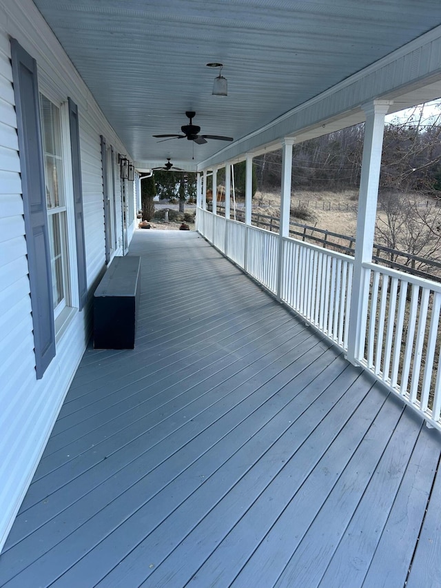 deck featuring covered porch and a ceiling fan