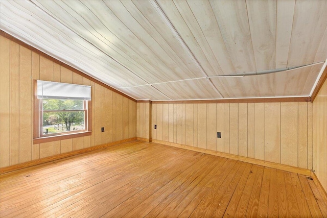 bonus room with wood-type flooring, wooden walls, lofted ceiling, and wood ceiling