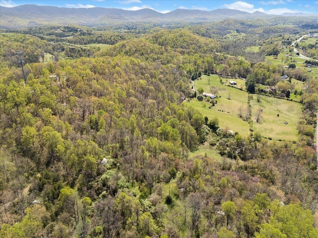 aerial view with a wooded view and a mountain view