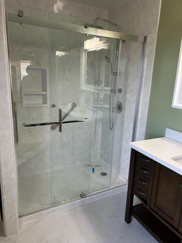 full bathroom with a stall shower and vanity