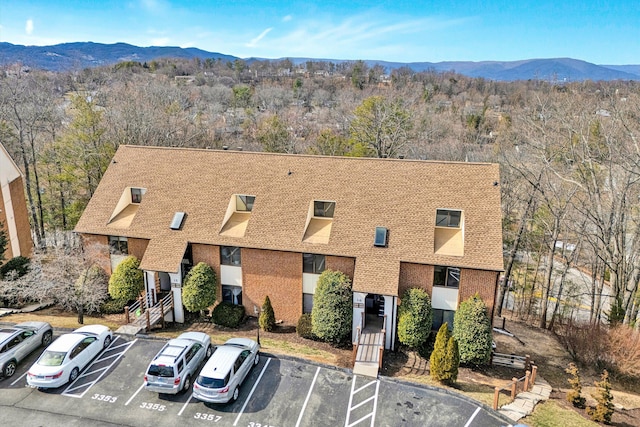 exterior space with a mountain view and a wooded view