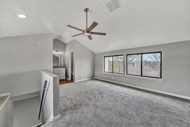 unfurnished living room with visible vents, lofted ceiling, baseboards, and carpet flooring