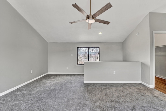 empty room with baseboards, a ceiling fan, and vaulted ceiling