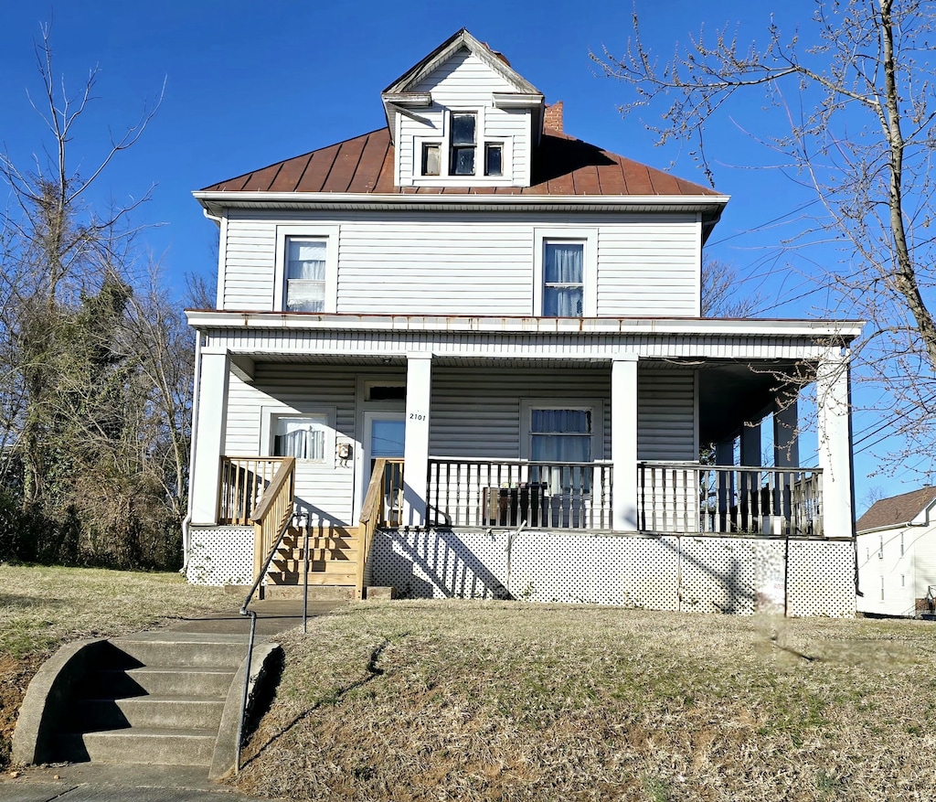 view of front of home featuring covered porch, metal roof, and a standing seam roof