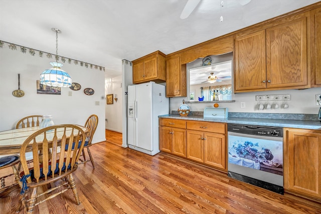 kitchen with dishwasher, white fridge with ice dispenser, light wood-type flooring, and brown cabinets