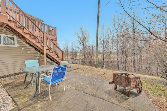 view of patio with stairway and outdoor dining area