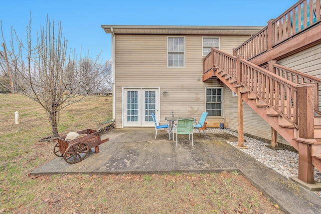 back of property with a deck, french doors, a patio, and stairway