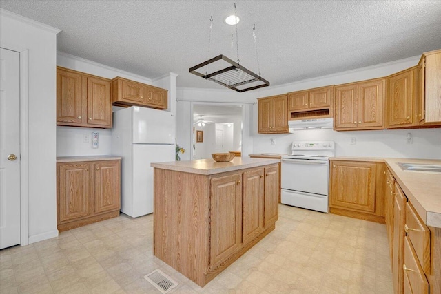kitchen featuring a kitchen island, white appliances, under cabinet range hood, and light floors