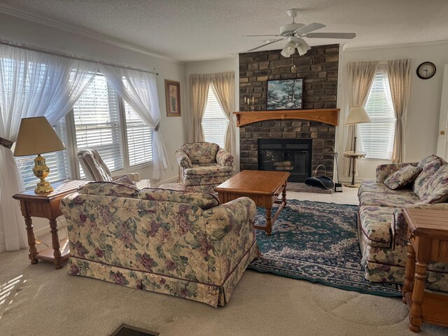 living area featuring a textured ceiling, a ceiling fan, carpet, and a wealth of natural light