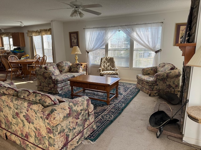 living room featuring ornamental molding, carpet floors, ceiling fan, and a textured ceiling