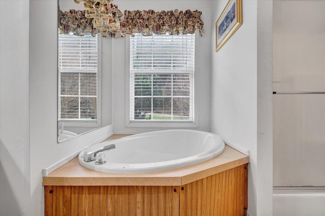 bathroom featuring an enclosed shower and a bath