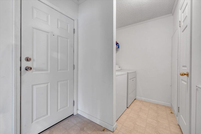 laundry area featuring separate washer and dryer, baseboards, a textured ceiling, laundry area, and light floors