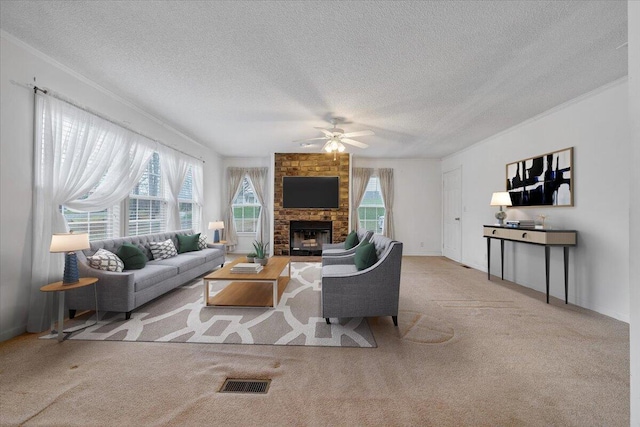 living room featuring a fireplace, a textured ceiling, a ceiling fan, visible vents, and carpet