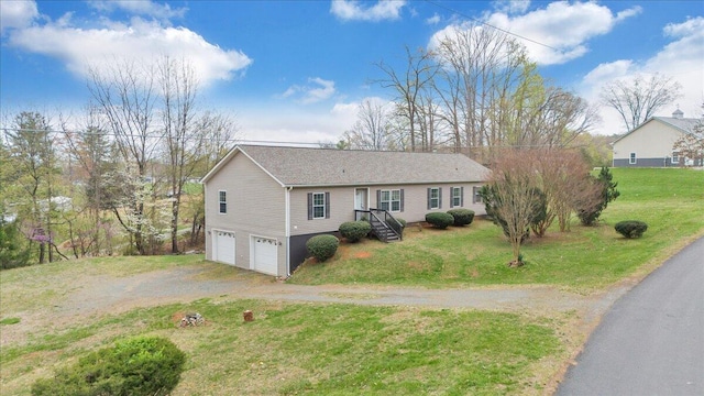 ranch-style home with driveway, an attached garage, and a front lawn