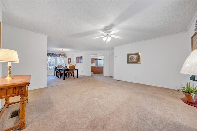 living room with carpet flooring, visible vents, a textured ceiling, and ceiling fan