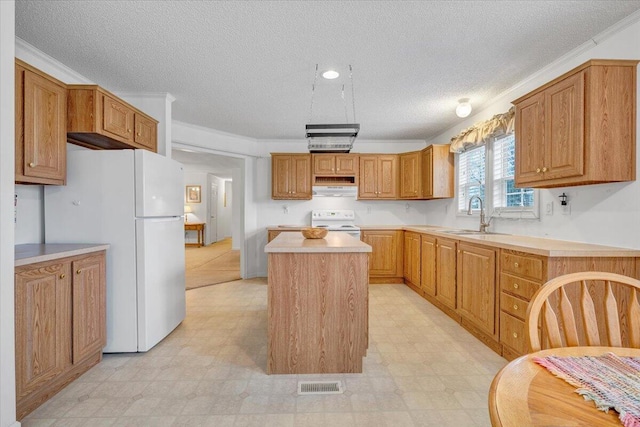 kitchen featuring white appliances, range hood, a center island, and light floors