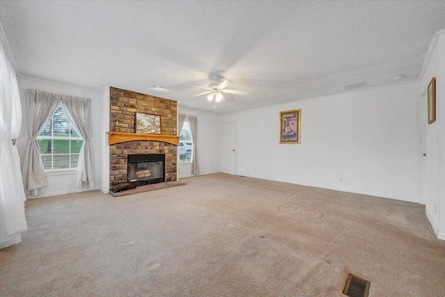 unfurnished living room featuring a large fireplace, visible vents, a ceiling fan, and carpet