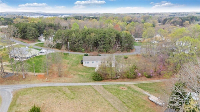 birds eye view of property with a wooded view