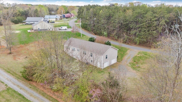 drone / aerial view featuring a wooded view