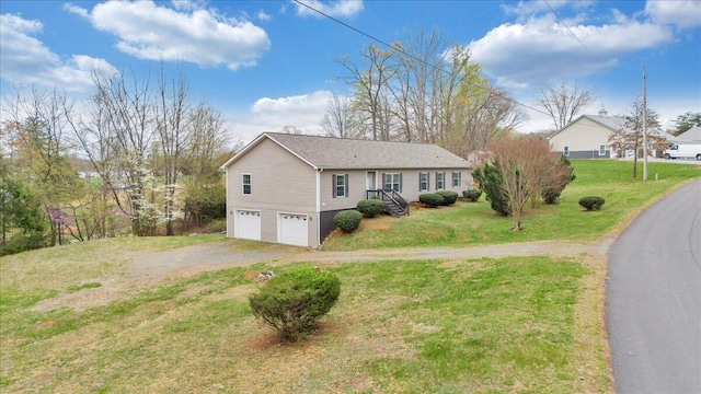 ranch-style home with an attached garage, driveway, and a front lawn