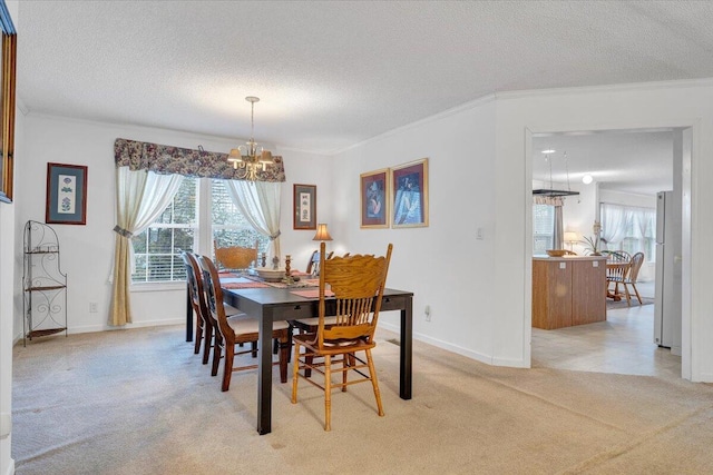 dining space with a chandelier, light carpet, crown molding, and a textured ceiling