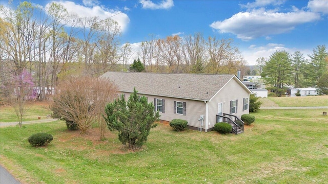 view of side of property featuring a yard