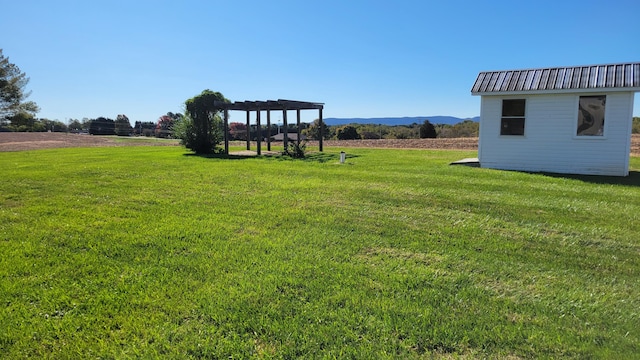 view of yard with an outbuilding and a pergola