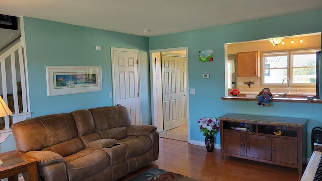 living area featuring baseboards and wood finished floors