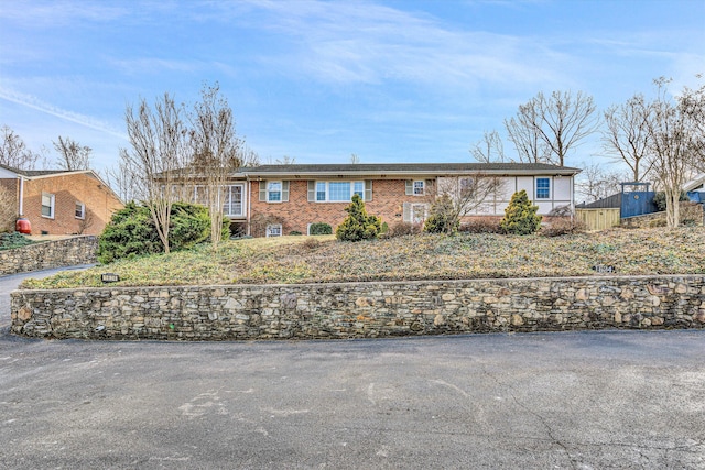 ranch-style house featuring brick siding