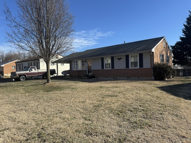 single story home with brick siding, a garage, and a front lawn