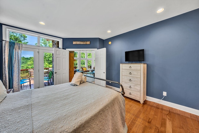 bedroom featuring recessed lighting, wood finished floors, baseboards, access to exterior, and french doors